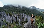 Tourist on Limestone pinnacles Borneo Malaysia 