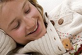 Girl with an outgoing gilded hamster of the collar of its sweater