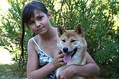 Portrait of a Girl and a Shiba Inu in a garden France 
