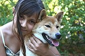 Portrait of a Girl and a Shiba Inu in a garden France 