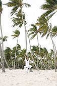 Woman and man praticing yoga on a beach in Martinique Island