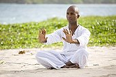 Man praticing yoga on a beach in Martinique Island
