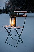 Lantern on a chair with snow in Provence 