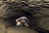 Caver in the underground river of Castade ; Section in "keyhole" 