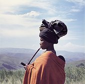 Xhosa woman with a traditional style turban smoking pipe