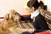 Woman and Golden Retriever on a sofa France 