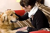 Woman and Golden Retriever on a sofa France 
