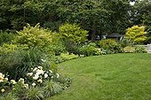 Lawn borded with mixed-border in a garden