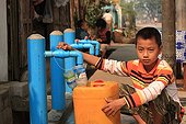 Boy filling his water bottle drinking Burma ; Taps the city's public