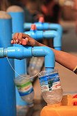 Boy filling his water bottle drinking Burma ; Taps the city's public