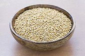 Dry mustard seeds in a wooden bowl ; Work plan in stone. Edible seeds sprout