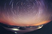 Circumpolar and star shooting Alps France ; From a lookout in the mountains, an hour of laying enough to demonstrate the rotation of stars above the sea of ​​clouds with the clouds scatter light to villages below. A shooting star leaves a short trail near the North Star.
