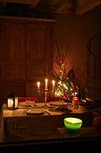 Candles lightning a dining room at night