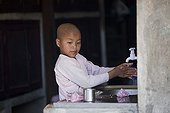 Nun washing hands in Nyaung Shwe Burma