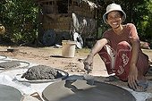 Woman producing water tanks for sale, Takeo Province, Cambodia