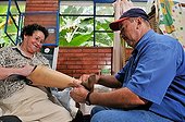 A lower limb prosthesis being fitted for a leprosy patient by an employee of the Deutsche Lepra- und Tuberkulosehilfe relief organisation, DAHW, at the leper colony in Agua de Dios, Colombia, South America