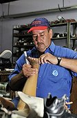 Man repairing a lower limb prosthesis at the orthopedic workshop of the Deutsche Lepra- und Tuberkulosehilfe relief organisation, DAHW, at the leper colony in Agua de Dios, Colombia, South America