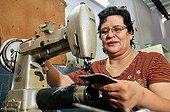 Woman working at a sewing machine, producing custom-made shoes for leprosy patients at the orthopedic workshop of the Deutsche Lepra- und Tuberkulosehilfe relief organisation, DAHW, at the leper colony in Agua de Dios, Colombia, South America