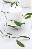 Mistletoe and candle on a table