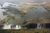 Aerial view of Victoria Falls Zimbabwe / Zambia  ; On the left the Main Falls (93m high, Zimbabwe), in the centre Livingstone Island (borderline Zimbabwe/Zambia), on the right the Rainbow Falls (108m, highest falls, Zambia).