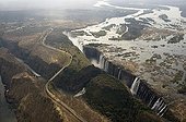 Aerial view of Victoria Falls Zimbabwe / Zambia  ;  From left to right: The Main Falls (93m high, Zimbabwe), Livingstone Island (borderline Zimbabwe/Zambia), the Rainbow Falls (108m, highest falls, Zambia) and the Eastern Cataract (Zambia). On the left the Victoria Falls Bridge which is no-man's-land between the Zimbabwean and Zambian border posts. 