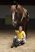 Woman making a exercise in trust with a horse  ; Daniela 24 years reaching problem of muscle development comes to the center for 10 years. She is passionate about the jump. <br>Equitherapy in partnership with the AAAEPAD Association and Ariel Pagani équitherapist<br>Asociacion Argentina de Actividades para Ecuestre Discapacitados 