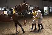 Woman making a exercise in trust with a horse  ; Daniela 24 years reaching problem of muscle development comes to the center for 10 years. She is passionate about the jump. <br>Equitherapy in partnership with the AAAEPAD Association and Ariel Pagani équitherapist<br>Asociacion Argentina de Actividades para Ecuestre Discapacitados 