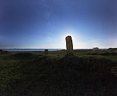 Standing stone hiding the moon in district - Britain France  ; Located Locmariaquer, Dolmen des Pierres-Plates is a covered walkway that opens onto an upright stone.