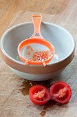 Harvest of tomato seeds ; Tomato seedsin a strainer. 
