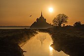 Mont Saint Michel and reflection at sunrise - France