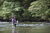 Young Woman fishing, Fly fishermen on the French-Swiss Doubs river, La Goule, Franche-Comté, France