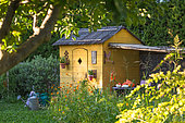Garden shack with seating area in july, Provence, France