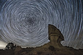 Rock formation in Los Monegros area in front of star trails during a clear february night, Aragon, Spain