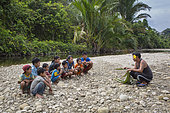 Teacher showing how to make a coconut palm basket, Pulau Siberut, Sumatra, Indonesia