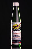 'Al-Kamal' rose water bottle (Rosa damascena) on black background, Taif, Saudi Arabia
