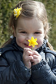 Girl holding narcissus Tete a Tete