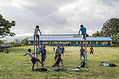 Children playing football in a school, Efate Island, Vanuatu