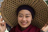 Korean teen girl with Chinese hat in Yunnan region of China