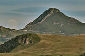 Full moon sunrise near Puy Mary (1783 m) in summer, Monts du Cantal, Auvergne Volcanoes Regional Nature Park, France