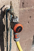 Timer installed on a garden hose, summer, Alsace, France
