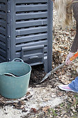 Harvesting of ripe compost in a garden composter. In commercial plastic composters, compost is harvested through the hatch at the base of the enclosure. Compost is good at harvesting when the composting elements are no longer recognizable and the compost has a black color and friable texture.
