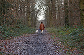 Woman walking her dog in the forest of Meudon, Hauts-de-Seine, Ile-de-France, France