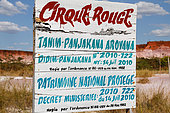 Sign announcing the red circus, ocher color, pink and white of laterite and friable sandstone, protected area 5 km from Majunga, West Madagascar