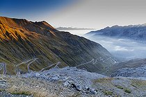 Stelvio Pass with mountains covered in snow and a winding road in the valley, Trentino-Alto Adige, Italy