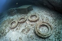 Photo denunciation, garbage in the sea, tire on submarine background. No matter the place if not the consequences.