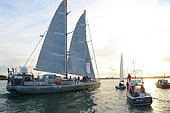 Departure of the Tara boat for two years expedition and scientific researchs on the oceans around the world. Here on the bay of Lorient with some greetings boats around. Owned by the Tara Ocean Foundation and mainly sponsored by the french fashion brand Agnes B, the boat will welcome more than 80 scientists during this trip. Lorient. Morbihan. France