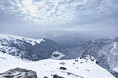 Lake Schiessrothried frozen seen from the snow-covered great Hohneck, Vosges, France