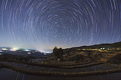 Polar star trails circle around the north celestial pole above Honghe Hani Rice Terraces, a world heritage sites in southwest China. The Honghe Hani Rice terraces cascade down the towering slopes of the Ailao Mountains, carved out of dense forest over the past 1,300 years by Hani people. The irrigated terraces support paddy fields overlooking narrow valleys. In some places there are as many as 3,000 terraces between the lower edges of the forest and the valley floor.