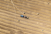 Making straw bales with a hay press in summer, Opal Coast, Pas de Calais, France