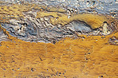 Detail at the shore of the Río Tinto (Red river). Its colour is caused by oxidised iron minerals. Aerial view. Drone shot. Huelva province, Andalusia, Spain.